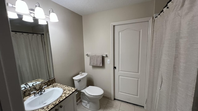 bathroom featuring tile patterned flooring, vanity, a textured ceiling, and toilet