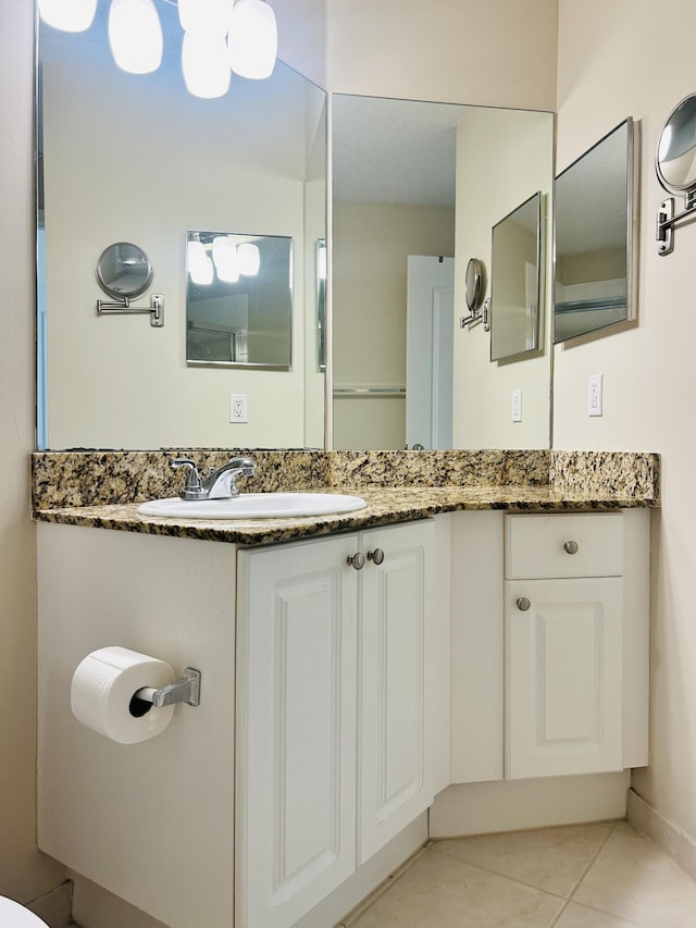 bathroom with vanity and tile patterned flooring