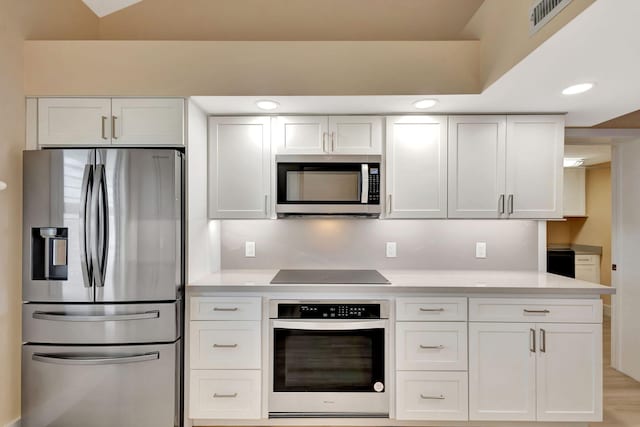 kitchen with white cabinetry, light hardwood / wood-style floors, and appliances with stainless steel finishes