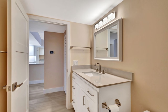 bathroom with hardwood / wood-style floors and vanity