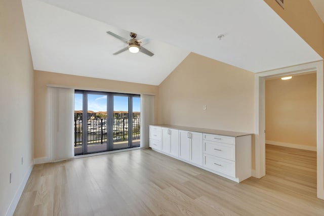 unfurnished living room with light wood-type flooring, high vaulted ceiling, and ceiling fan