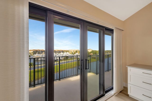 entryway featuring a water view and light wood-type flooring