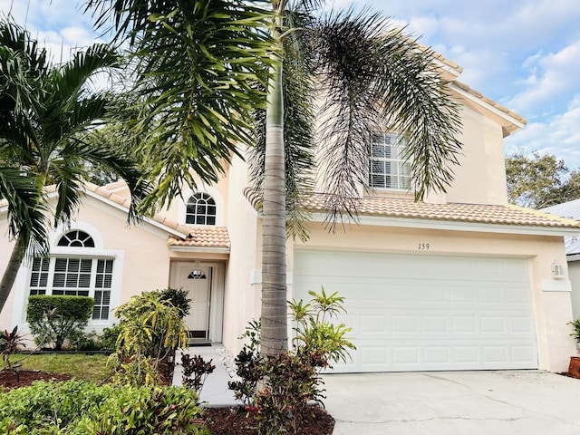 mediterranean / spanish-style house with a garage