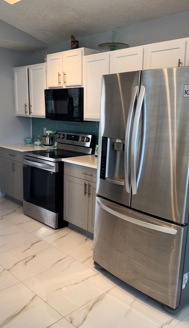 kitchen featuring appliances with stainless steel finishes, tasteful backsplash, white cabinetry, and gray cabinetry