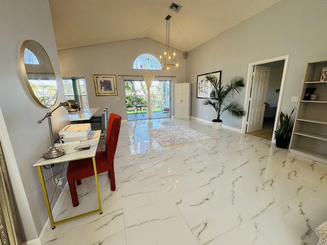 entryway with a chandelier and high vaulted ceiling