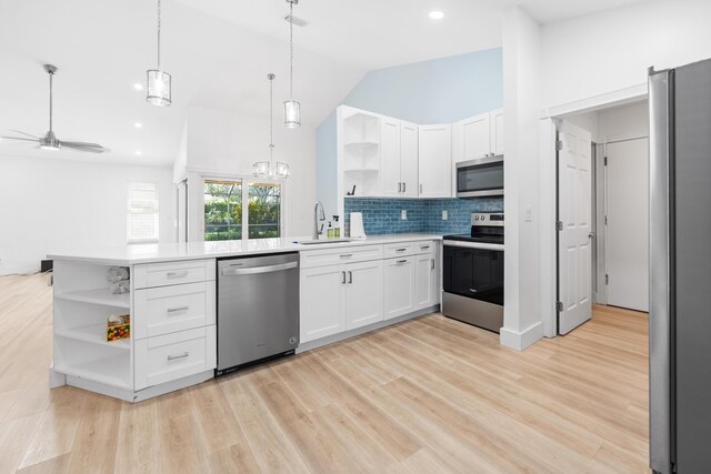 kitchen with white cabinets, decorative light fixtures, stainless steel appliances, and ceiling fan