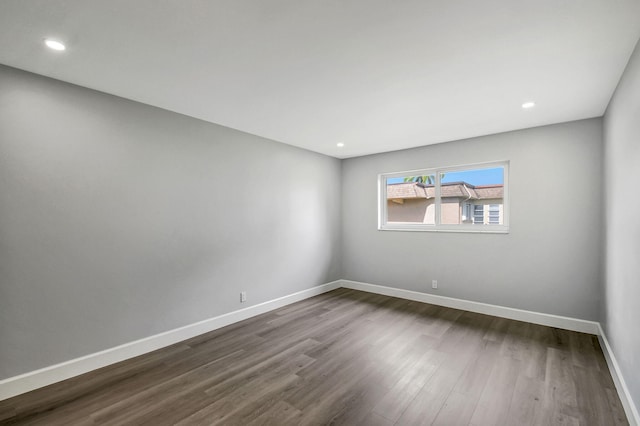 empty room with dark hardwood / wood-style floors