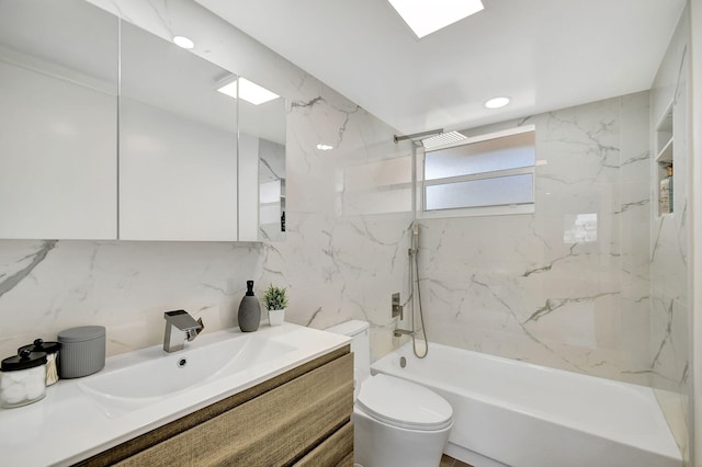 full bathroom featuring toilet, decorative backsplash, tiled shower / bath combo, and vanity