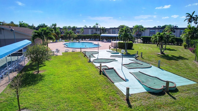 view of pool featuring a yard