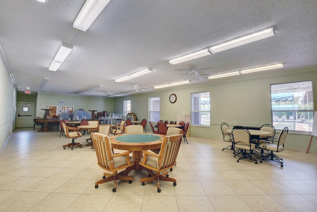 tiled dining room with ceiling fan and ornamental molding