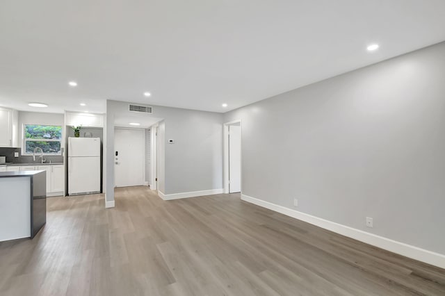 interior space with light hardwood / wood-style floors and sink