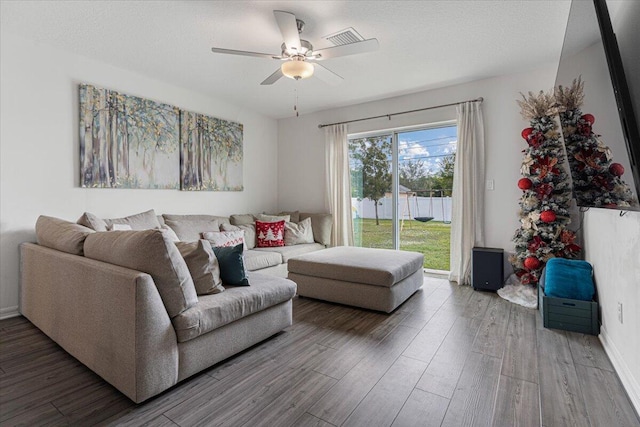 living room featuring ceiling fan and hardwood / wood-style flooring