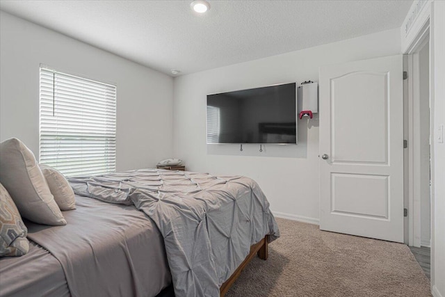 bedroom featuring a textured ceiling and carpet