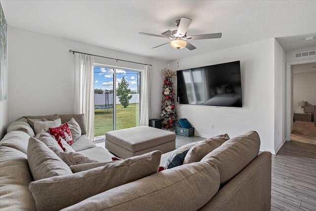 living room with hardwood / wood-style flooring and ceiling fan