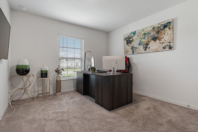 office featuring a textured ceiling and light carpet