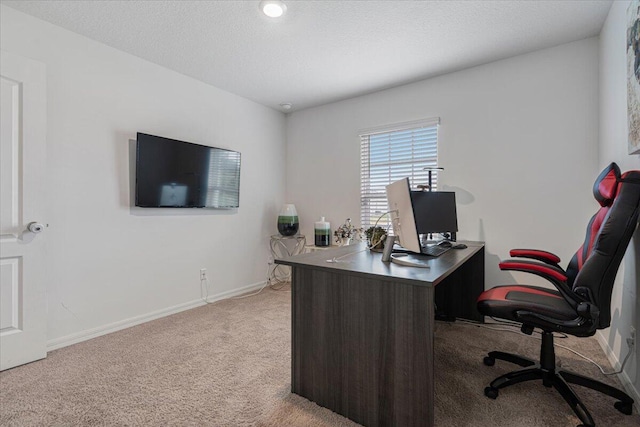 home office with light colored carpet and a textured ceiling