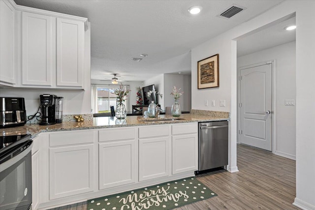 kitchen with sink, range with electric cooktop, white cabinets, and dishwasher