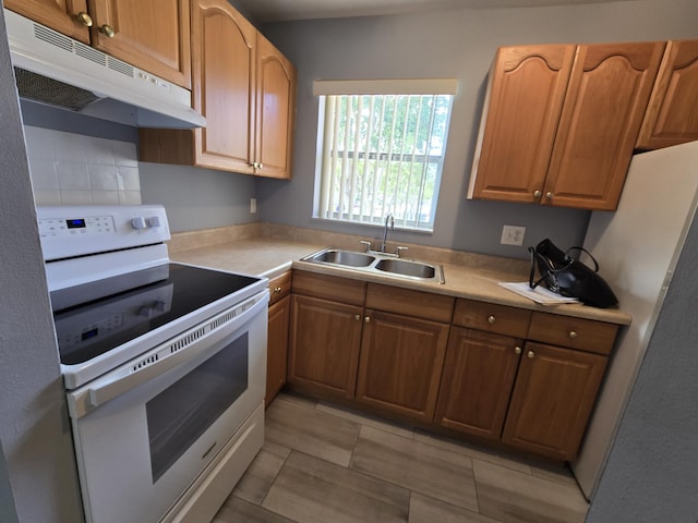 kitchen with backsplash, sink, and white appliances