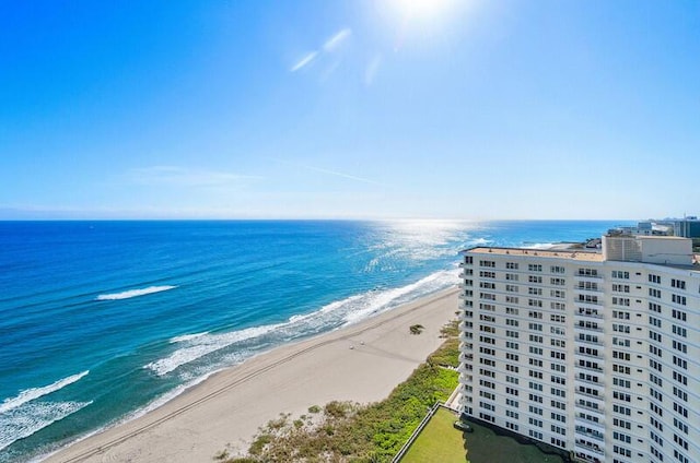 drone / aerial view with a water view and a beach view