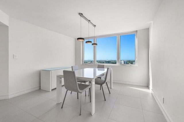 dining room with light tile patterned floors and rail lighting