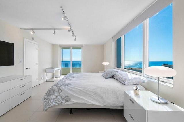 tiled bedroom with a water view