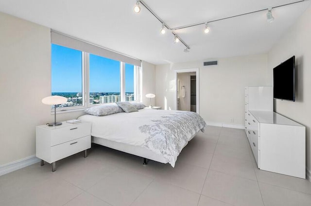 bedroom with light tile patterned floors