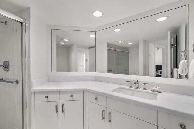 bathroom featuring vanity and a shower with shower door