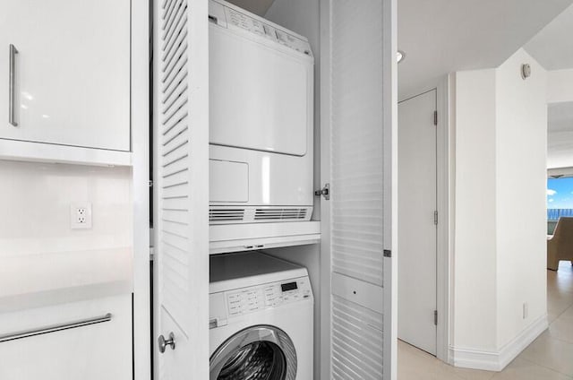 laundry area with stacked washer / drying machine