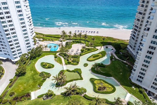 drone / aerial view featuring a water view and a beach view