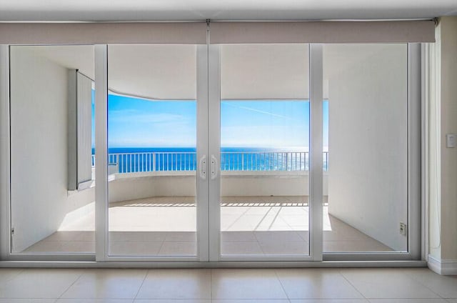 entryway with a water view and light tile patterned floors