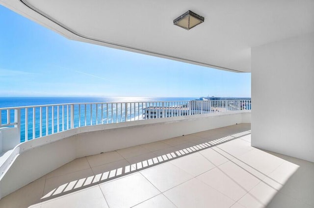 balcony with a water view and a beach view