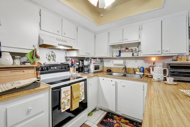 kitchen with sink, white cabinets, white appliances, and light tile patterned floors