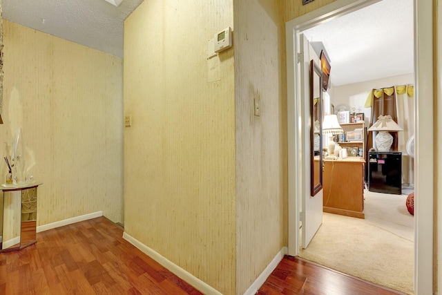 hallway with hardwood / wood-style flooring