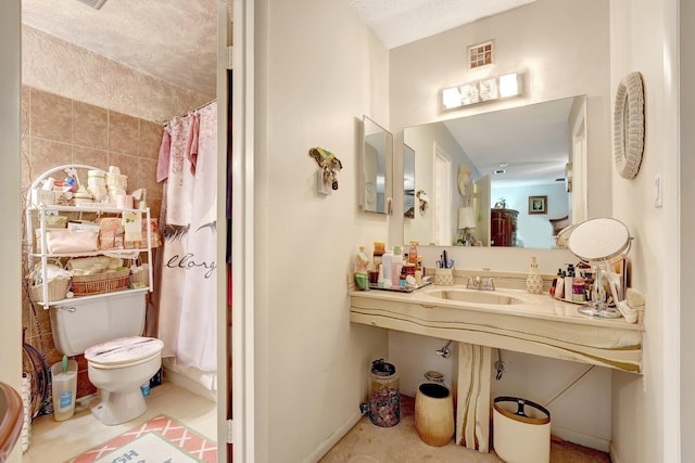 bathroom with a shower with curtain, toilet, and sink