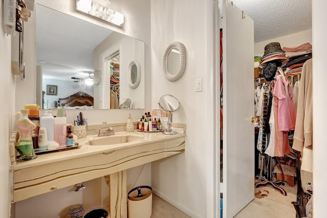 bathroom with sink and a textured ceiling