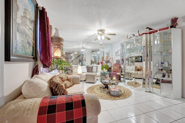 tiled living room featuring ceiling fan and a textured ceiling