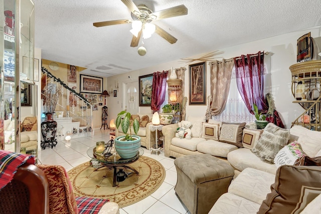 tiled living room featuring ceiling fan and a textured ceiling