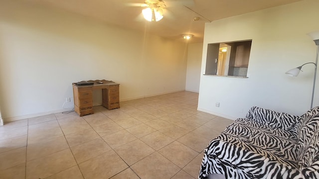 interior space with ceiling fan and light tile patterned floors