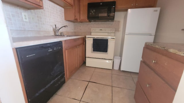 kitchen with light tile patterned floors, sink, backsplash, and black appliances