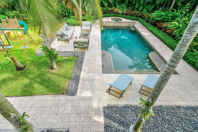 view of pool featuring a playground, an in ground hot tub, an outdoor hangout area, and a patio