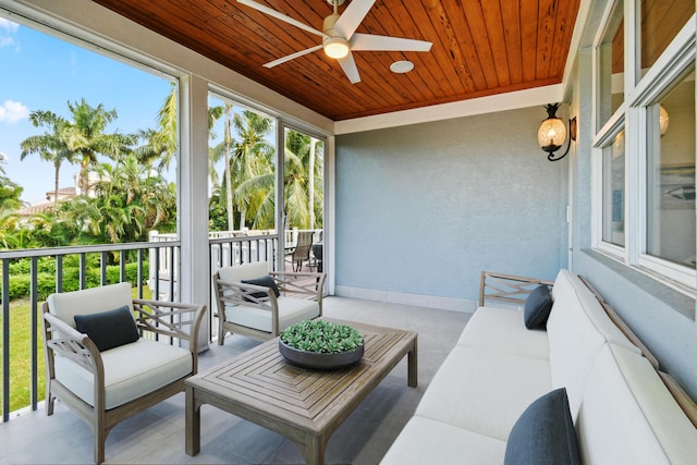 sunroom with ceiling fan and wooden ceiling