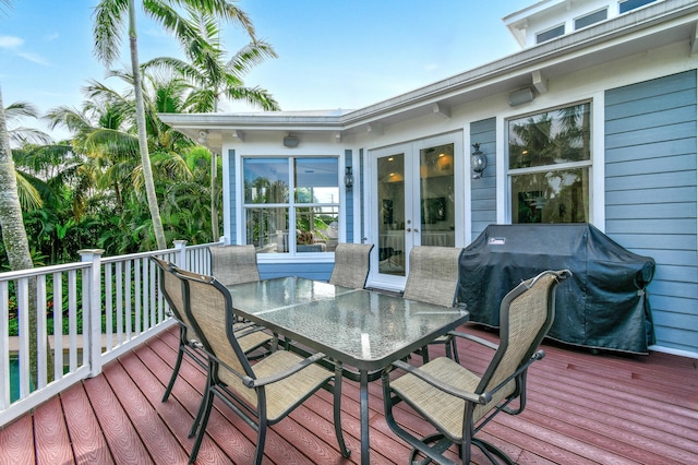 wooden terrace with area for grilling and french doors