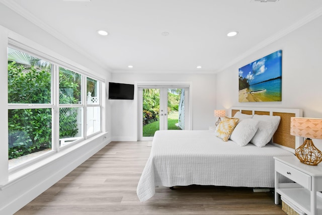 bedroom featuring ornamental molding, light hardwood / wood-style floors, french doors, and access to outside