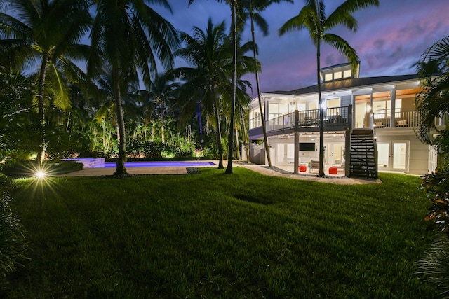 yard at dusk with a patio area