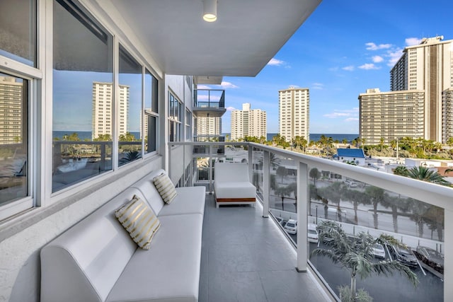 balcony featuring a water view and an outdoor hangout area