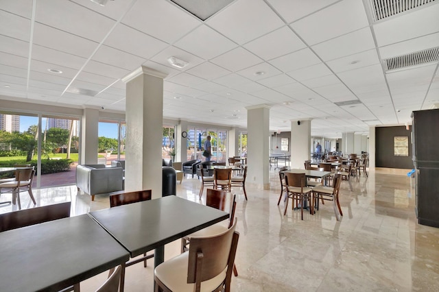 dining space featuring a drop ceiling