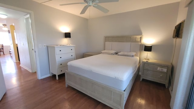 bedroom with ceiling fan and dark wood-type flooring