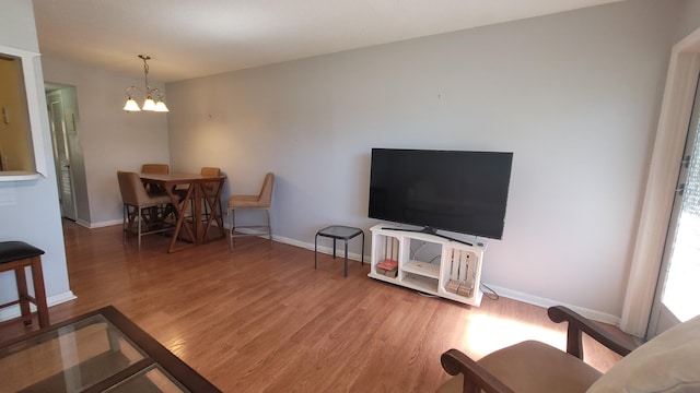 living room featuring a chandelier and hardwood / wood-style floors