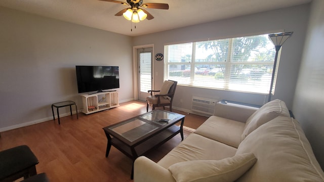 living room featuring an AC wall unit, ceiling fan, and hardwood / wood-style floors