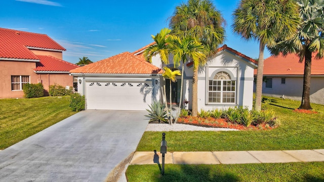 mediterranean / spanish-style home with a front yard and a garage